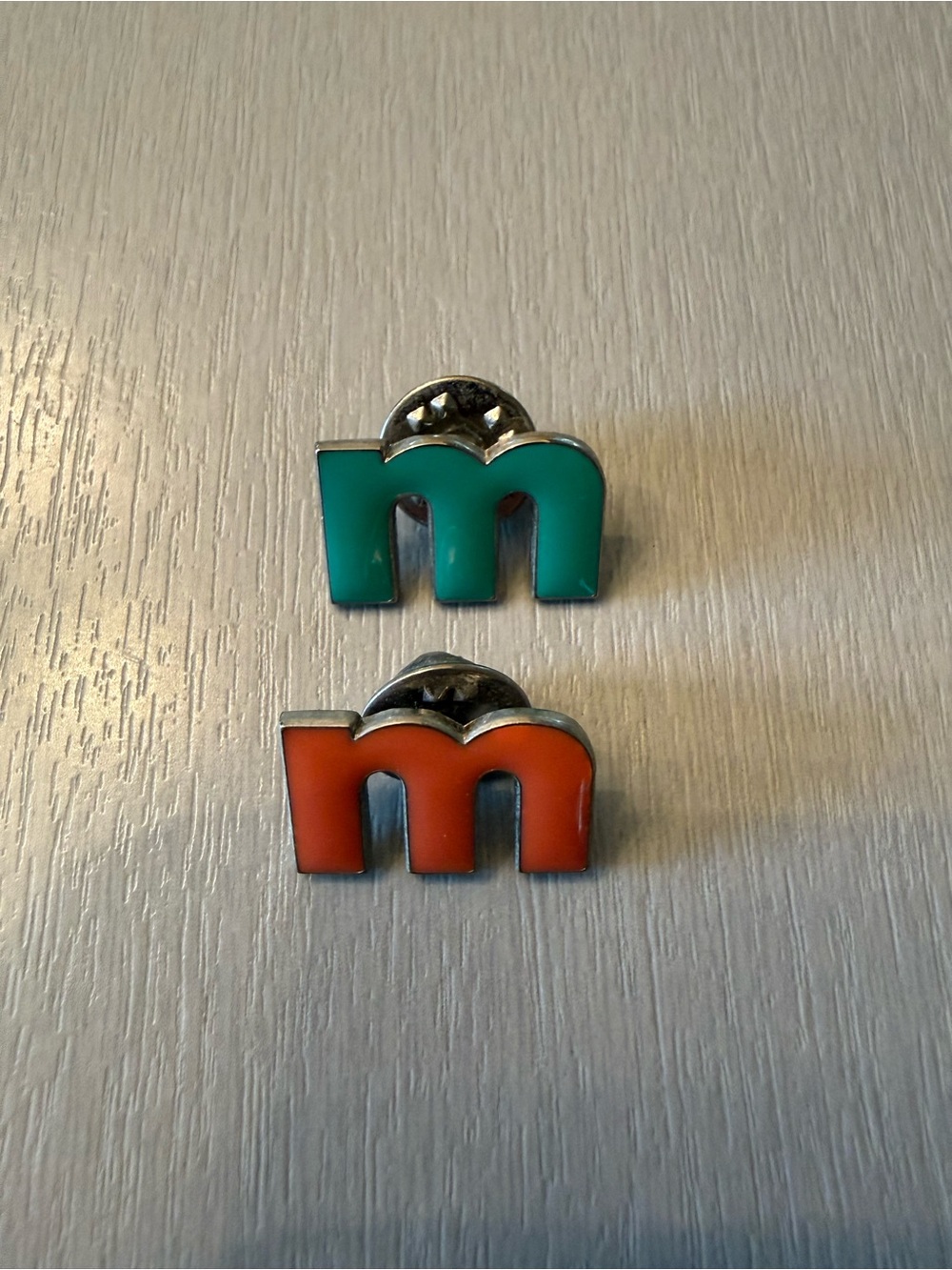 Enamel 'm' Lapel Pins - aqua and orange